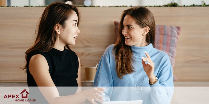 Two Women Drinking Coffee Discussing Mortgages